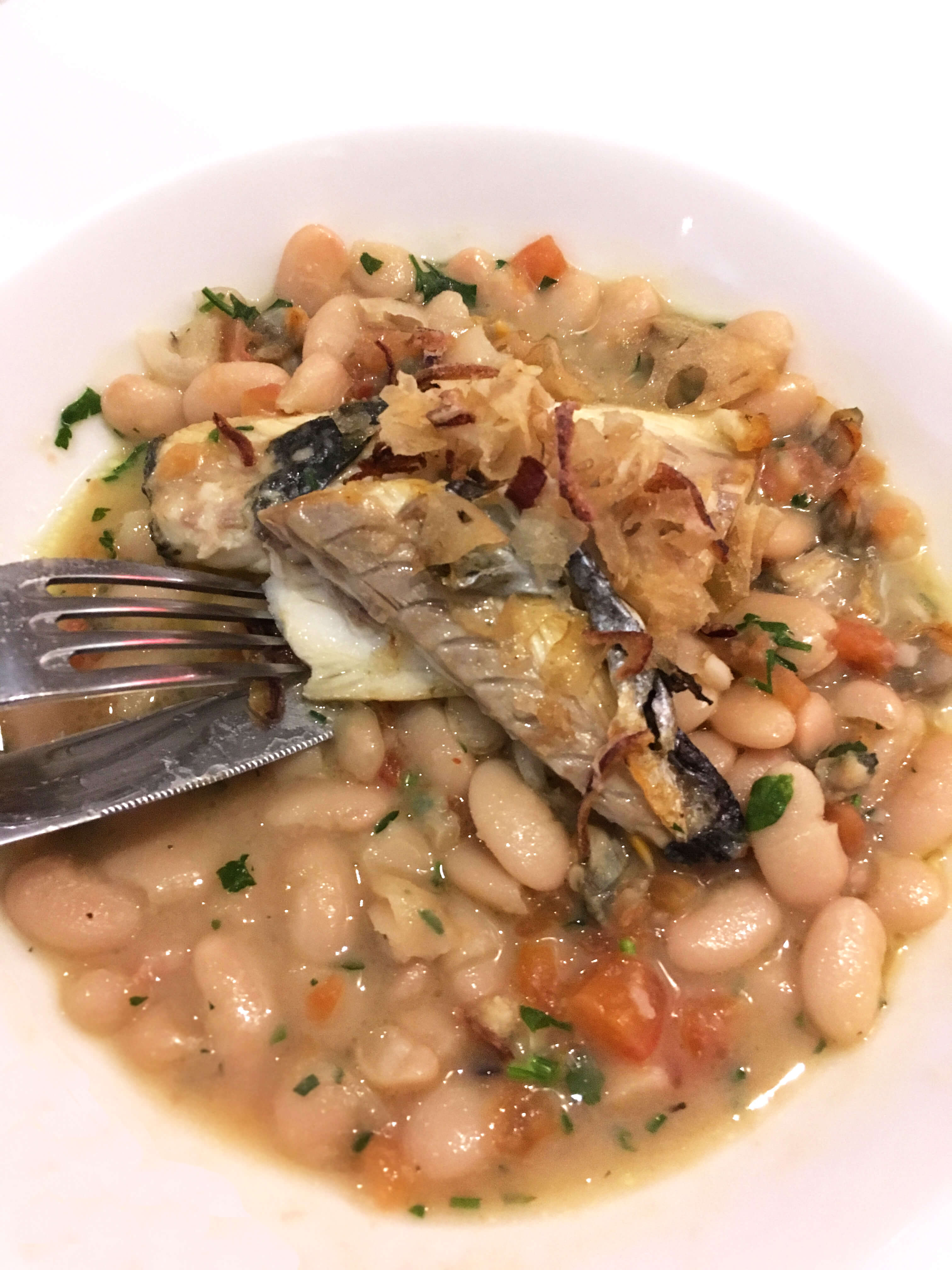 Sea bass filets, served with butter beans and clams